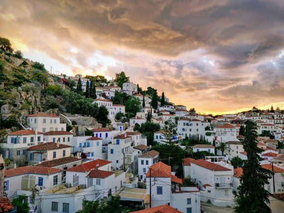 hydra island, white and brown concrete houses under cloudy sky during daytime