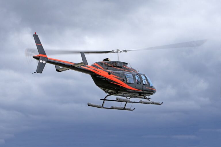 Red and Black Helicopter Flying in the Sky