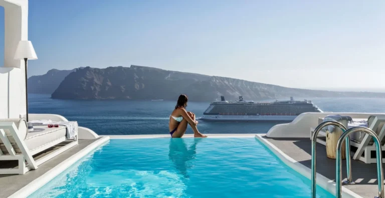 woman by the pool in santorini, greece tours