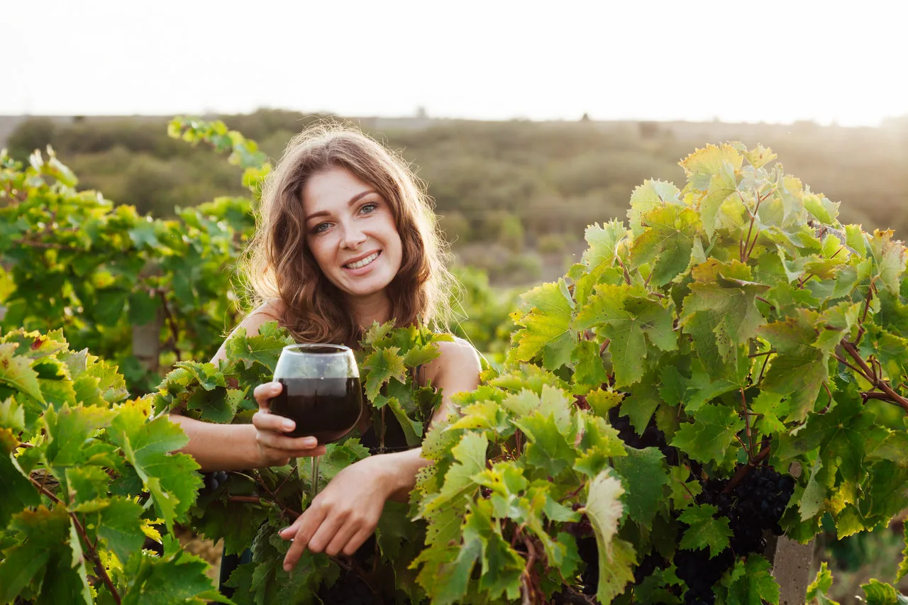 wine tasting tour, woman with a glass of wine in the vineyard