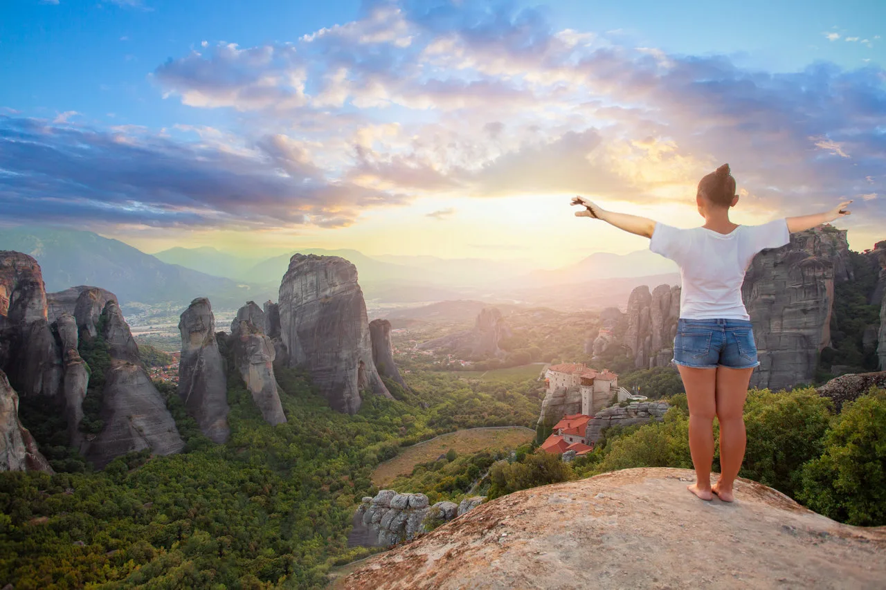 woman looking at the meteora rocks and monasteries